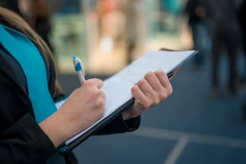 woman holding clipboard